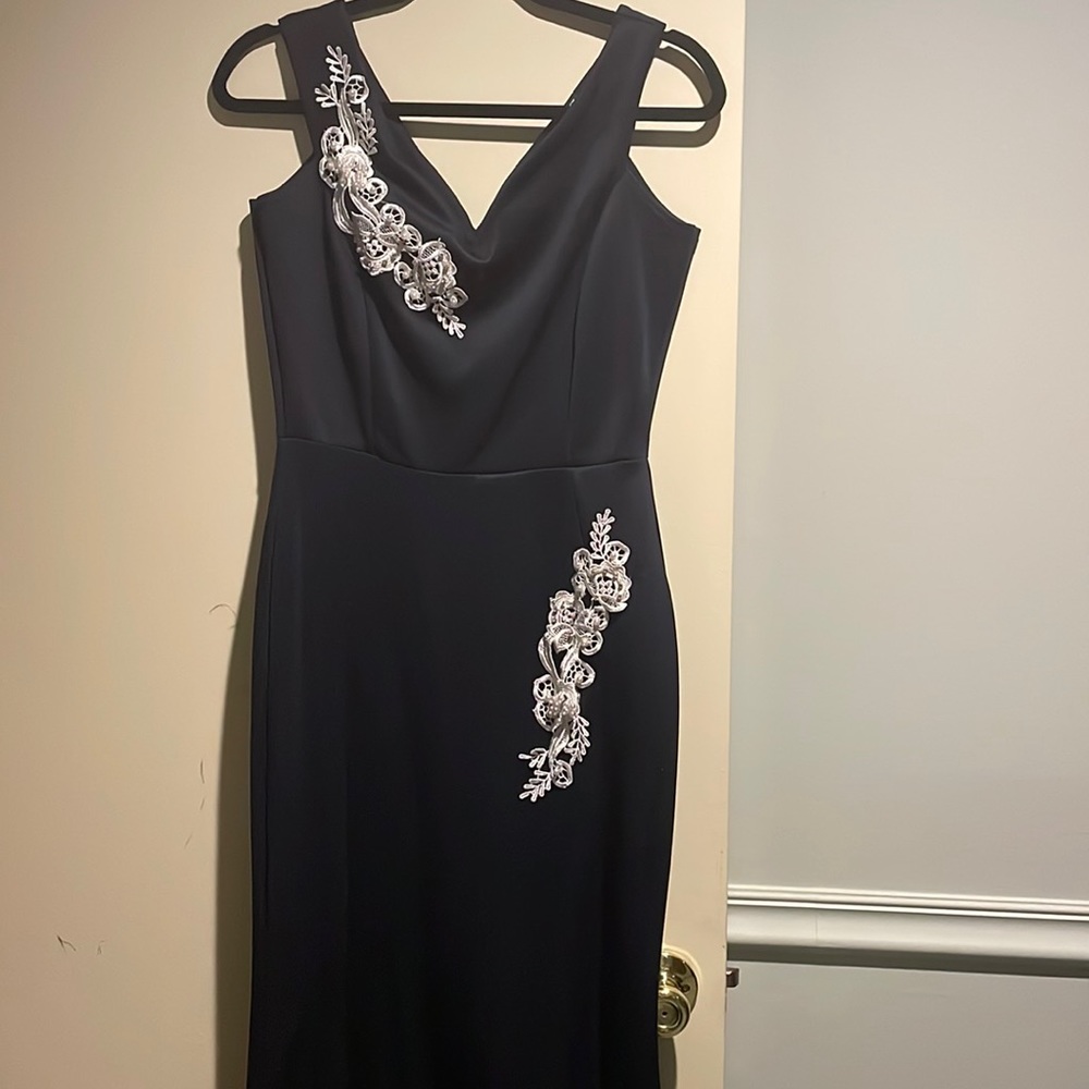 Black/dark blue sleeveless floor length trumpet dress. White beaded appliqués